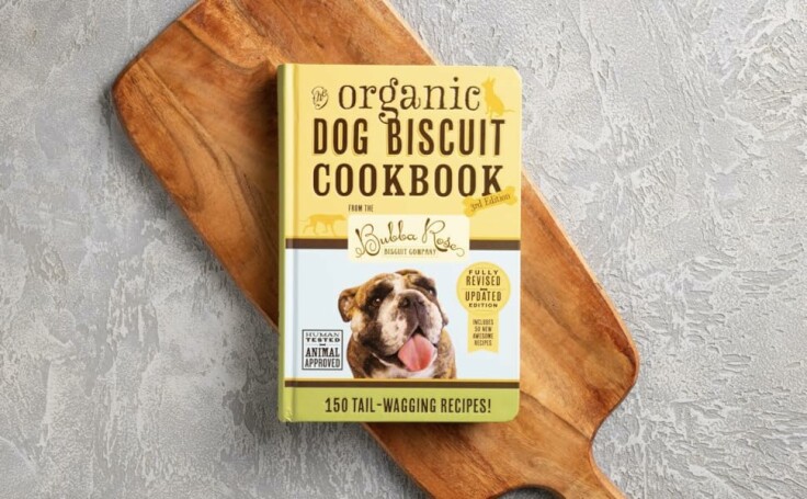 Image of a dog enjoying a homemade treat from the cookbook.